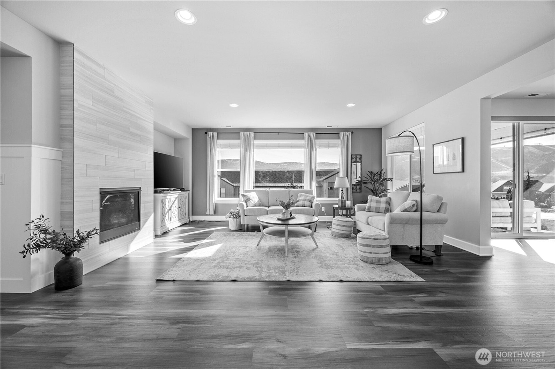Minimalist living room with floor-to-ceiling windows and sculptural furniture